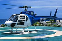 The old MVO support helicopter, a Aerospatiale AS-350B Ecureuil, named "Montserrat Air Support Unit" landing in the Barbados